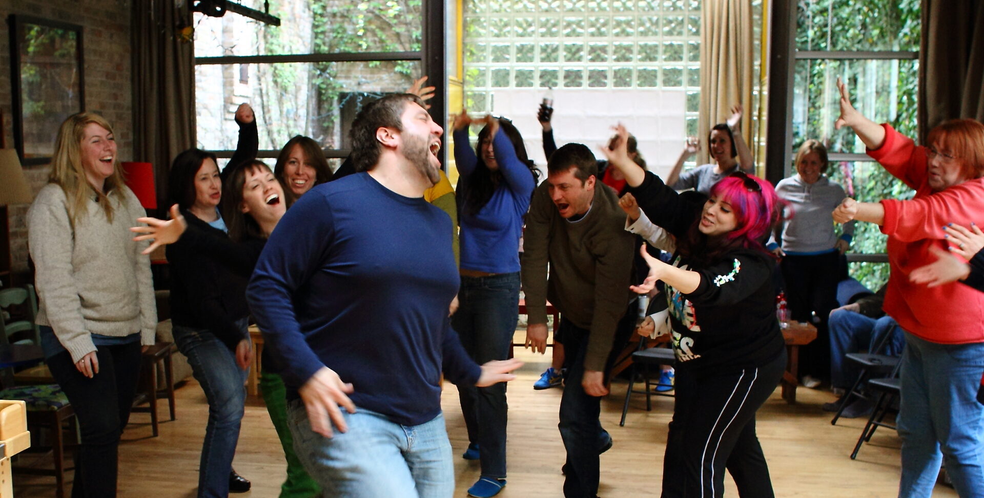 Pete Aiello leads a group of laughing participants